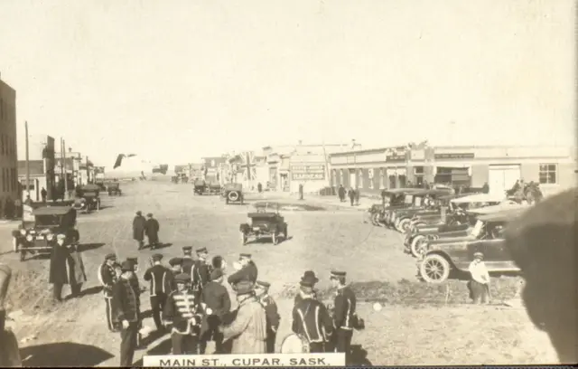 Main Street with band and parked cars